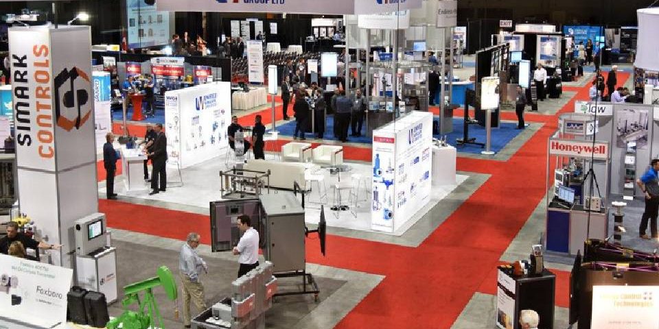 Customers having a look at the products showcased at various stall during a trade show.