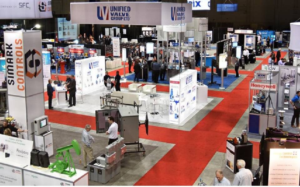 Customers having a look at the products showcased at various stall during a trade show.